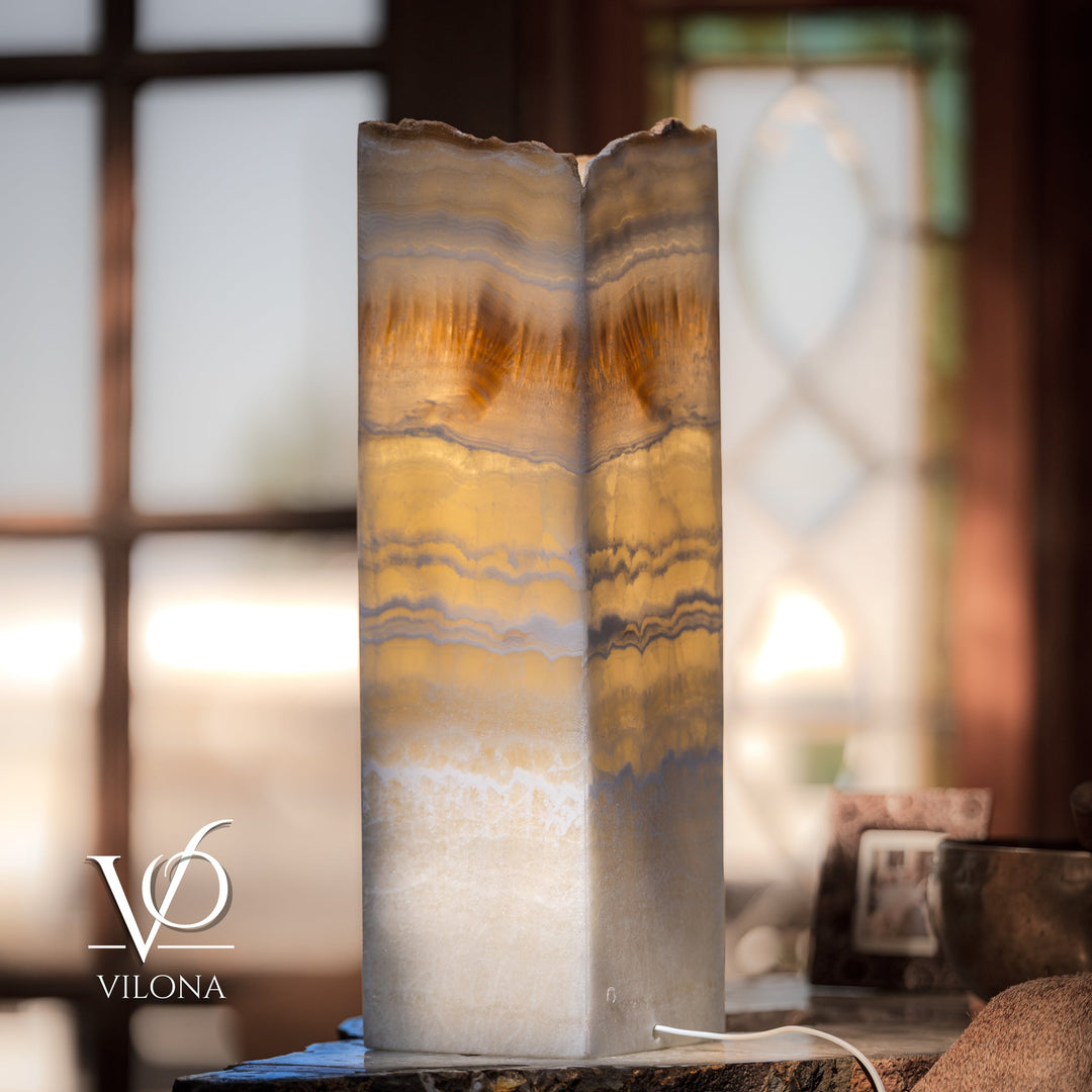 Square onyx table lamp with cream, amber-veined shade and scalloped top edge