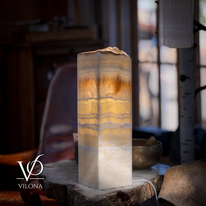 Square onyx table lamp with glowing cream onyx shade and amber horizontal bands