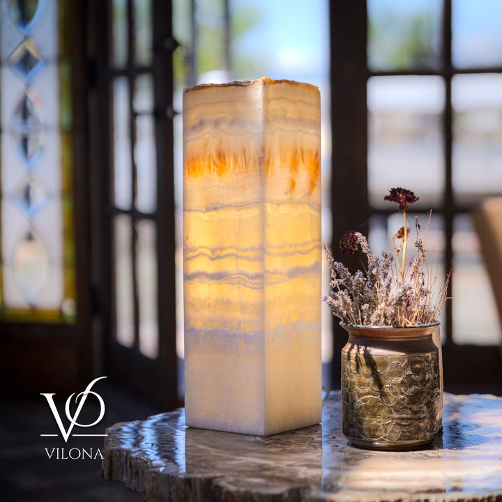 Square onyx-style lamp with cream translucent sides and warm amber light through