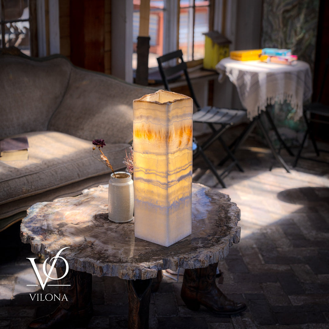 Square onyx-style table lamp with cream translucent shade and warm amber glow