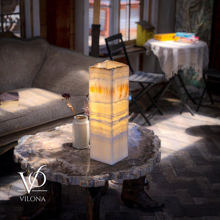 Square onyx-style table lamp with cream translucent shade and warm amber glow