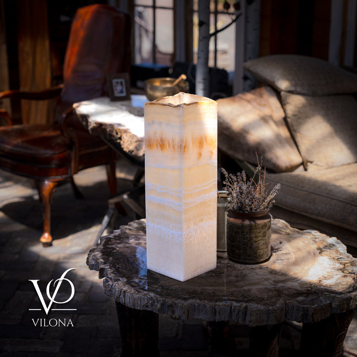 Square onyx-style table lamp with translucent cream shade and warm amber glow