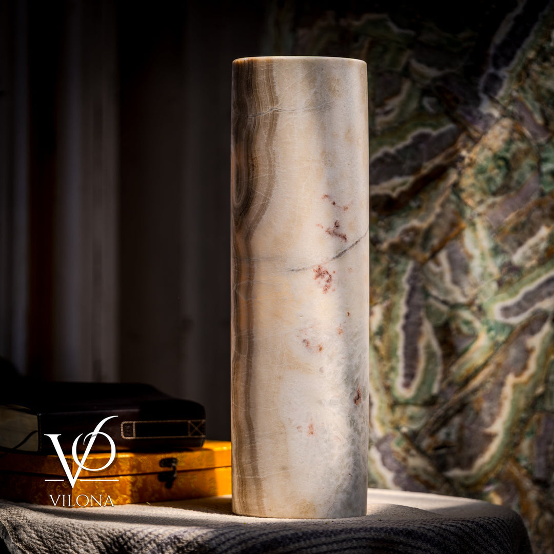 Tall cream cylindrical stone table lamp with subtle dark veining; smooth drum sides.