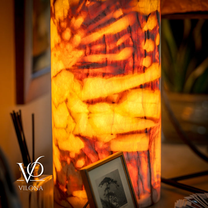 Onyx-style table lamp with amber marble-pattern shade, lit with warm glow