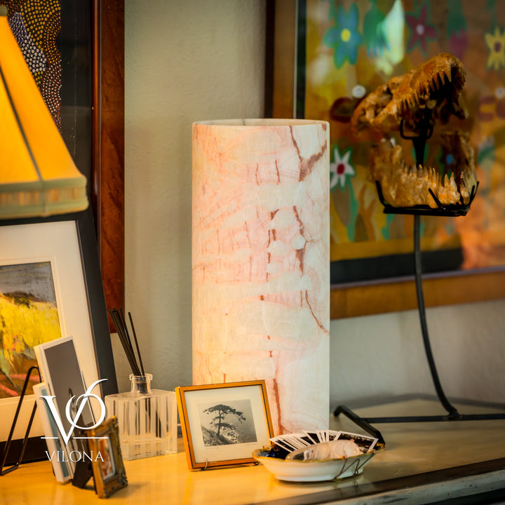 Table lamp with off-white cylindrical shade and slim black base stand.