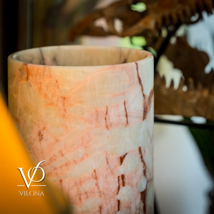 Table lamp shade close-up with warm amber and off-white marbled texture.