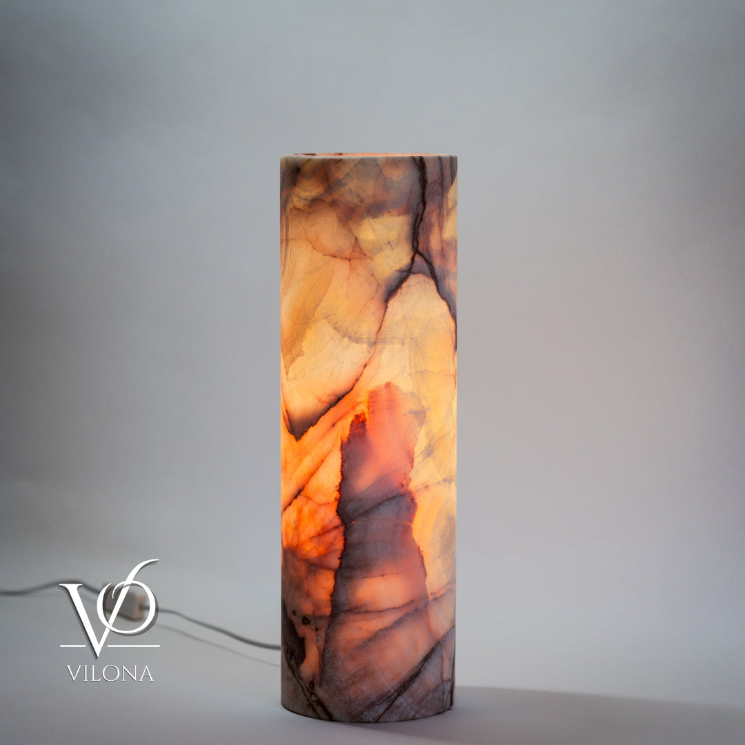 Cylindrical onyx-pattern table lamp with warm orange and dark veining