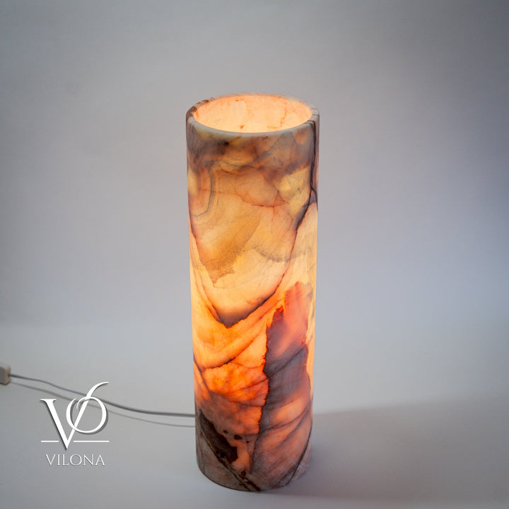 Cylindrical onyx-pattern table lamp with warm orange marbling; open top