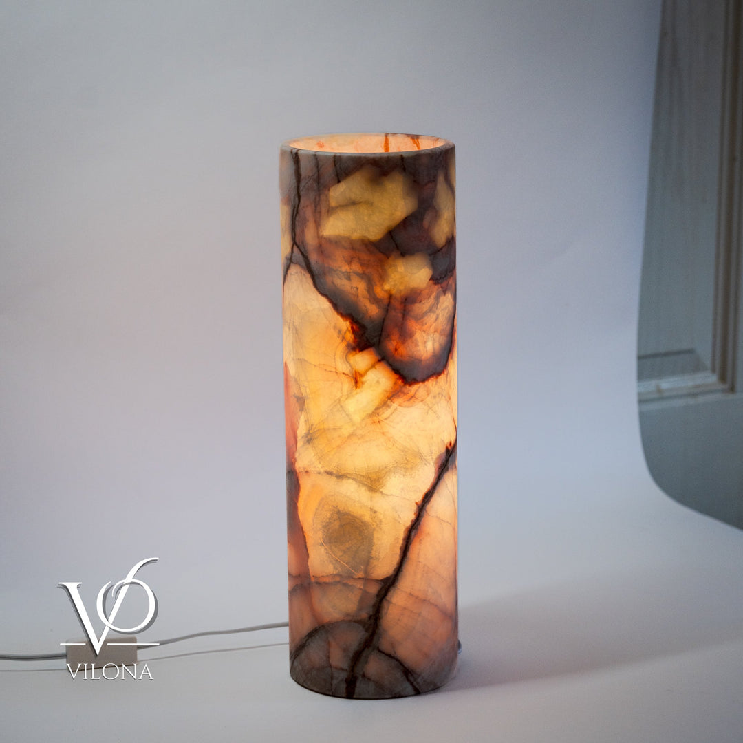 Cylindrical onyx-pattern table lamp with warm amber and brown marbled veins