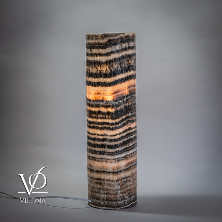Cylindrical onyx table lamp base with layered black, beige, and cream wave stripes