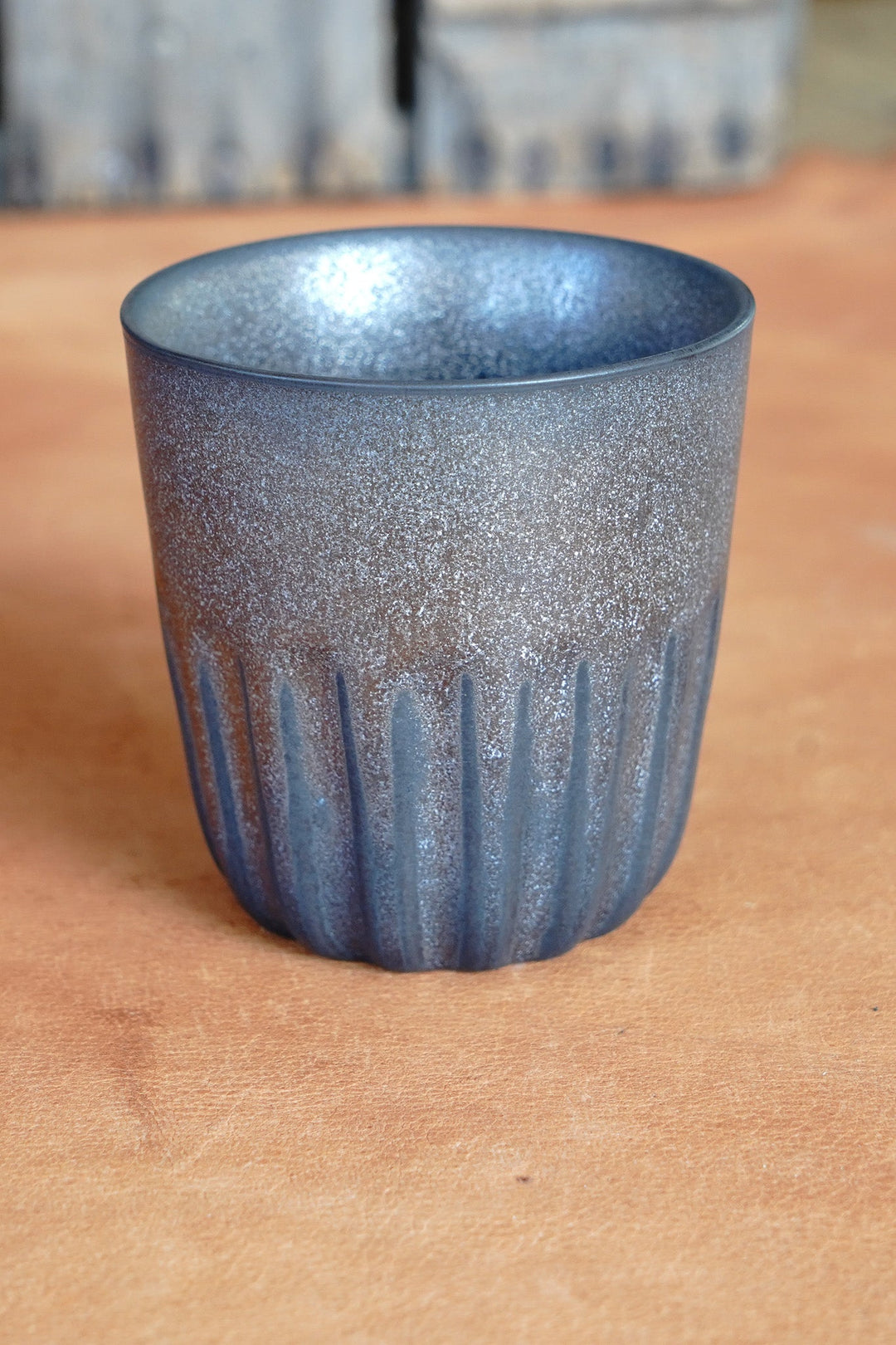 Metallic dark blue mug with speckled texture and fluted side design