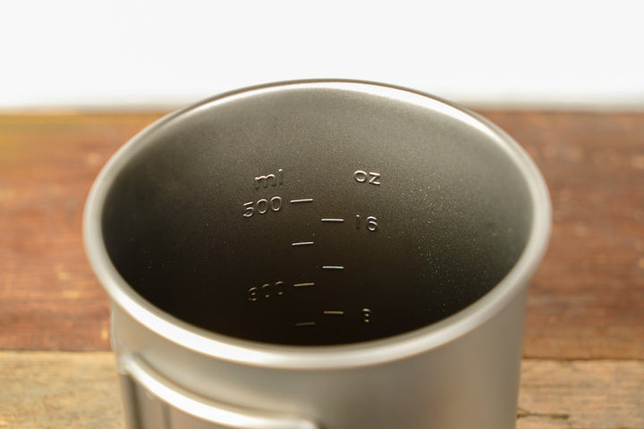 Inside view of metal camp cup with volume and measurement markings