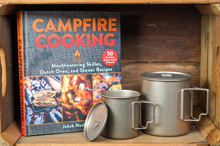 Metal camp cup with lid and side handle, with volume measurement markings on body
