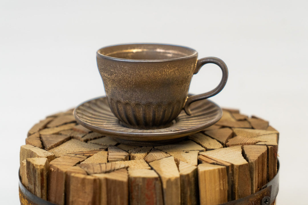 Rustic espresso cup and saucer on wood-slice base, dark brown speckled finish