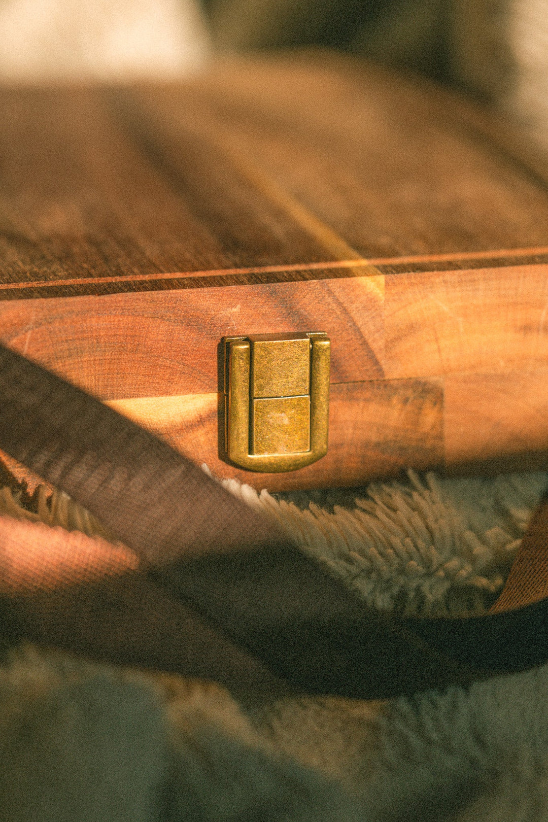 Folded wooden cheese board clasp with dark webbing handle