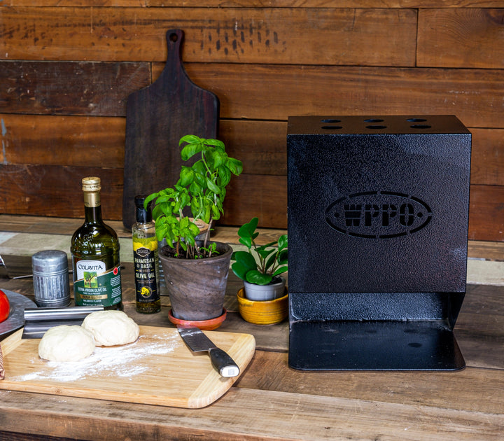 Black utensil holder with oval logo on outdoor kitchen counter