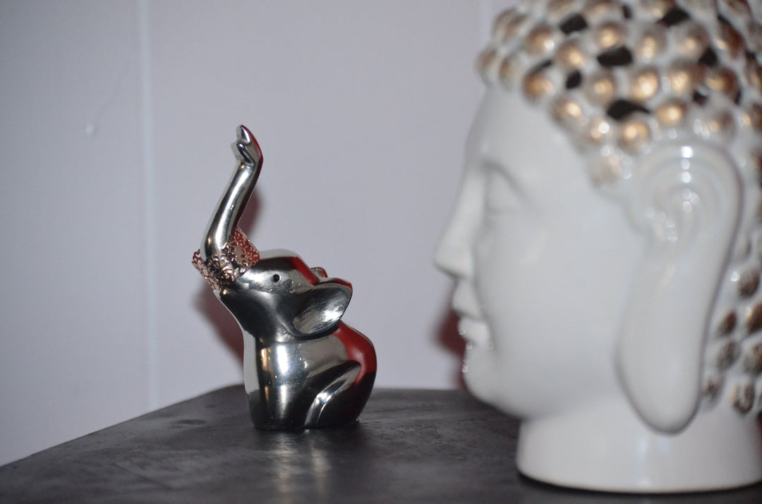 Metal elephant ring holder figurine with red accents, raised trunk detail