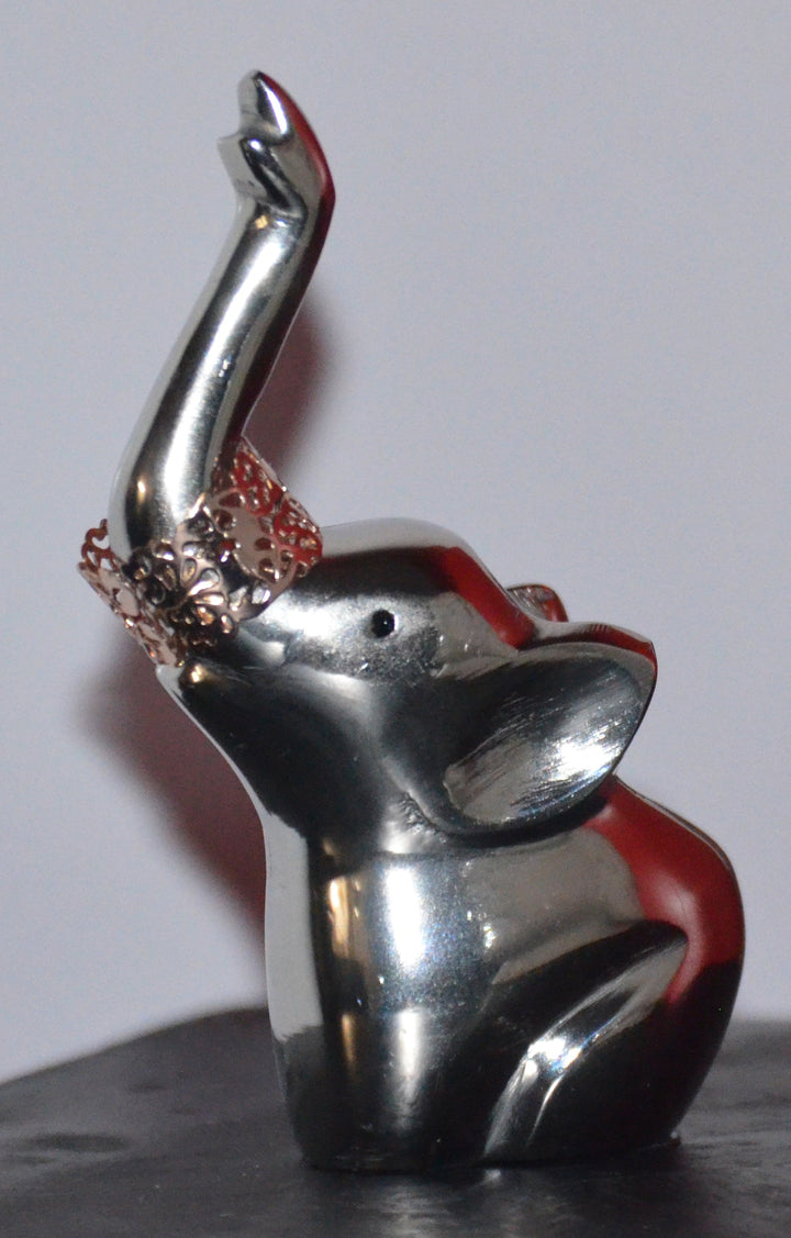 Metal elephant ring holder with red and silver accents, raised trunk