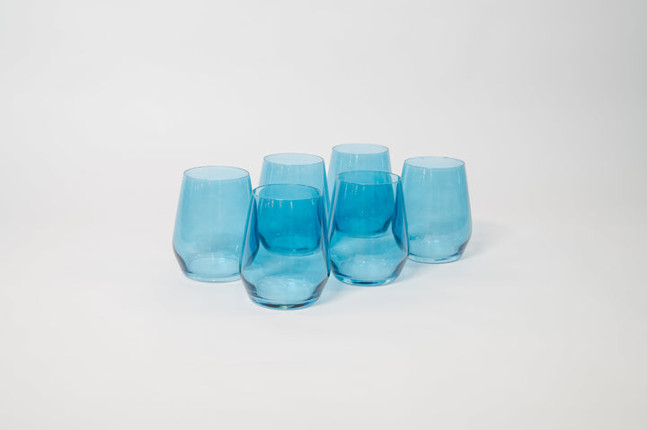 Five blue tinted stemmed wine glasses grouped together with clear stems.
