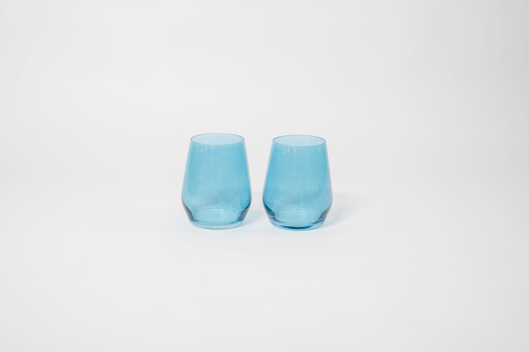Two blue tinted stemmed wine glasses with flared rims and clear stems.