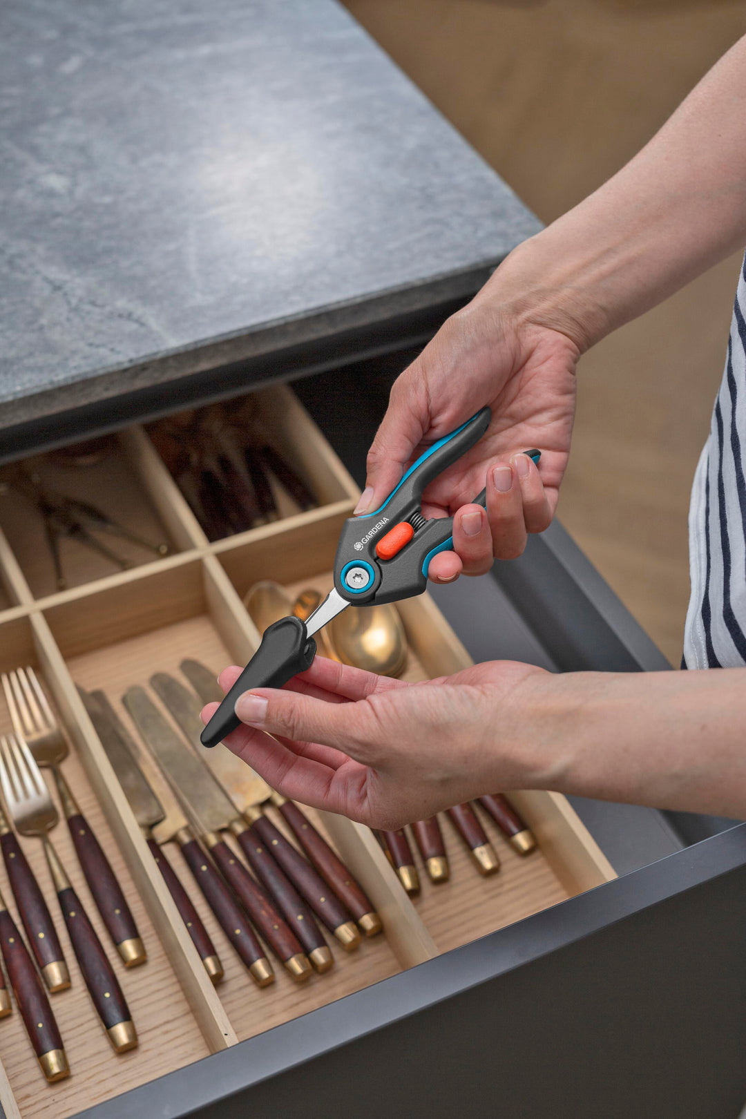 FreshCut Scissors with teal handles and orange latch placed near utensils.