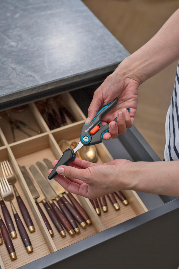FreshCut Scissors with teal handles and orange latch placed near utensils.