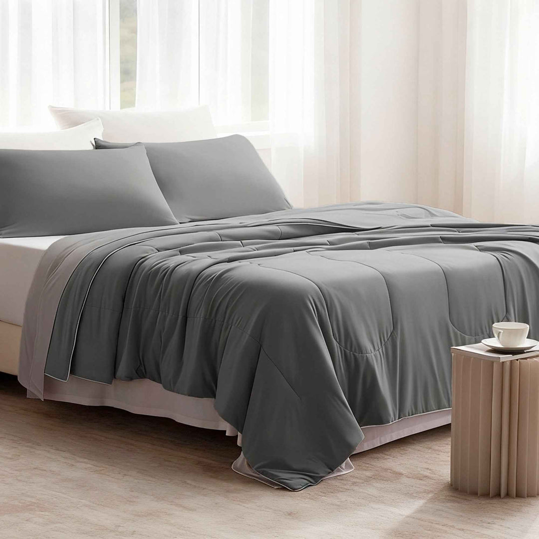 Dark gray cooling comforter set on bed with matching shams