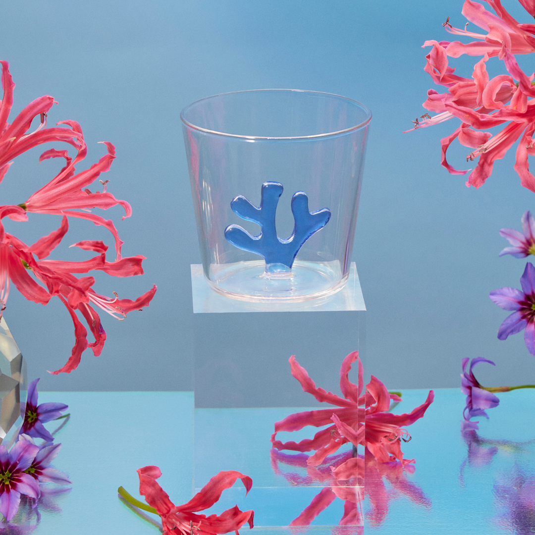 Water tumbler with clear glass and dark blue coral-shaped silicone insert