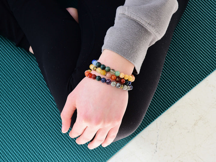 Rainbow beaded bracelet on wrist with multicolor round stone beads