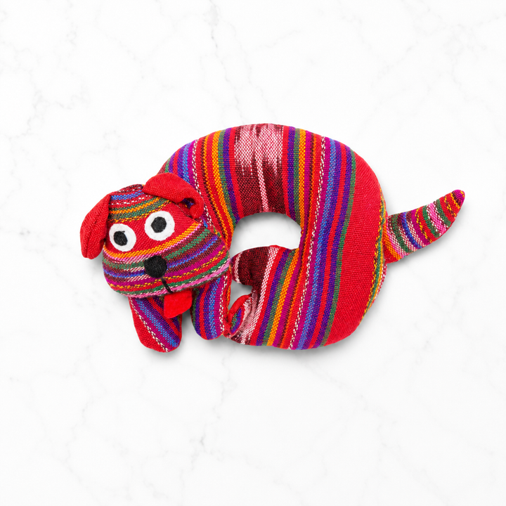 Fabric dog-shaped trivet with rainbow stripes and red dog ears and face
