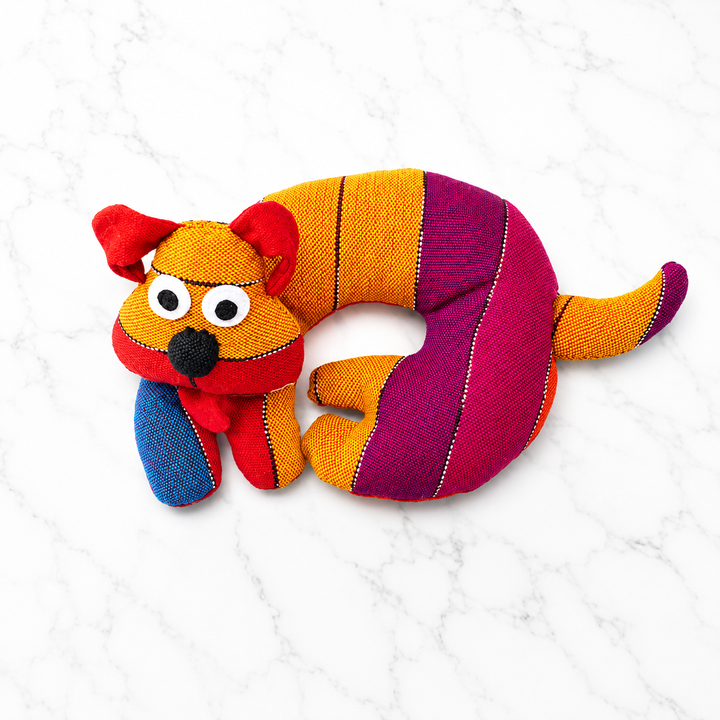 Fabric dog-shaped trivet with multicolor striped body, red dog face, and orange nose