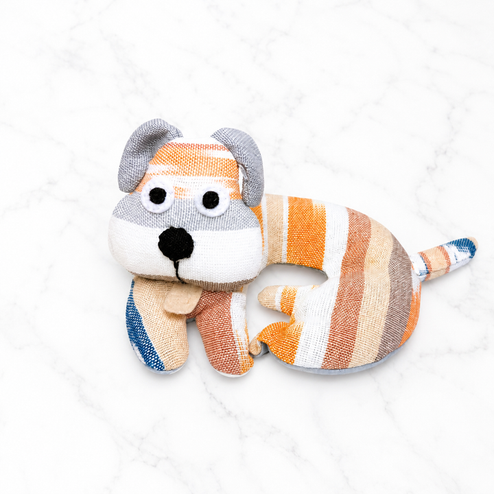 Fabric dog-shaped trivet with striped body and orange, white, and blue accents