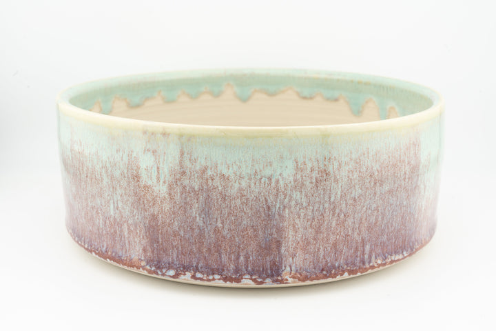 Ceramic dog bowl, turquoise rim and purple-brown speckled exterior glaze