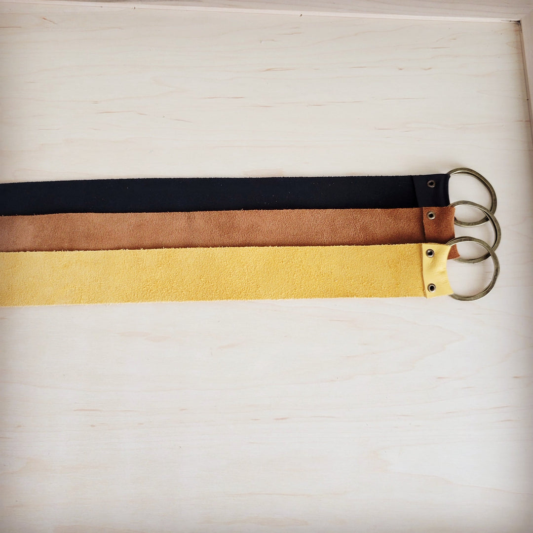 Leather belt with black strap, mustard panel, and two round ring closures
