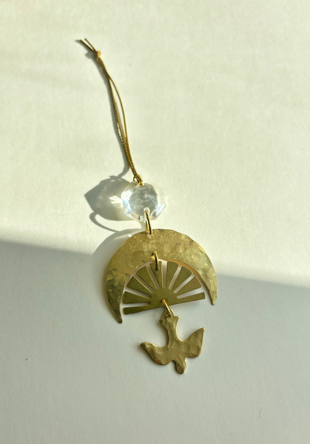 Gold fan charm ornament with blue glass crystal, bird detail, and hanging loop