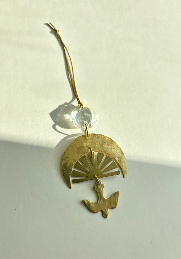 Gold fan charm ornament with blue glass crystal, bird detail, and hanging loop