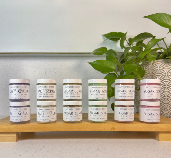 Velvet Vanilla coffee scrub jars arranged on a wooden shelf with matching labels