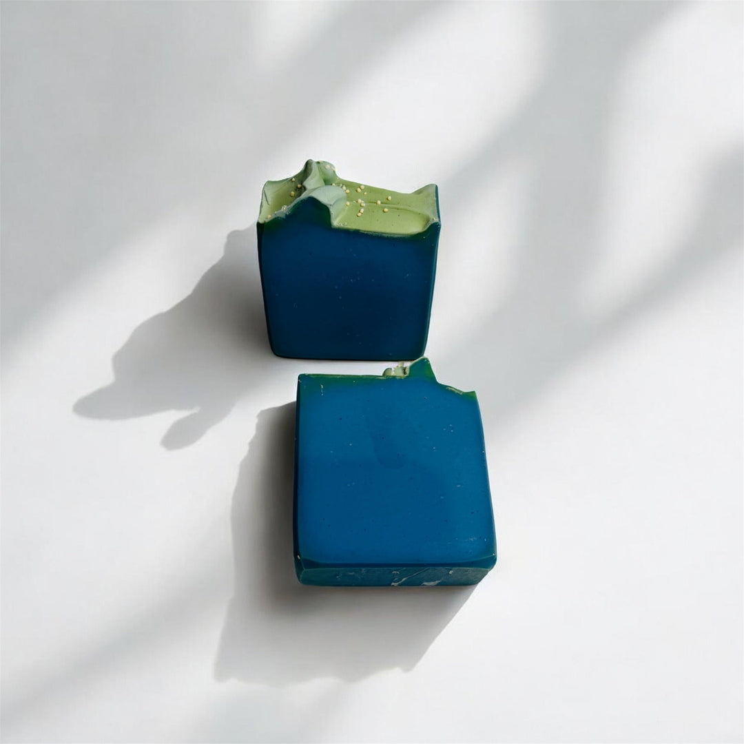 Handmade orris soap, dark blue bar with green accents, stacked pair