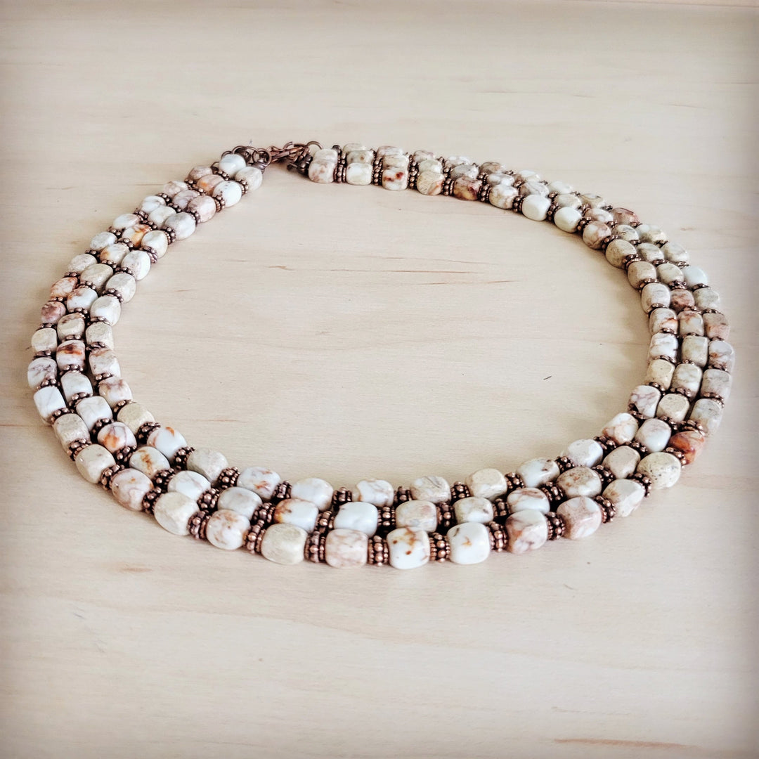 Triple-strand beaded necklace, white and brown cube beads with copper-toned links