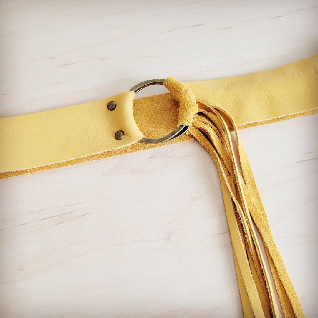 Mustard leather belt with round ring buckle and leather fringe detail