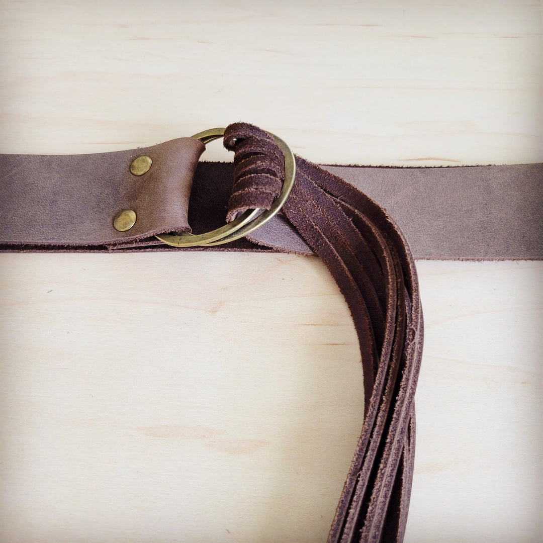 Brown leather belt with brushed metal buckle and distressed fringe strands