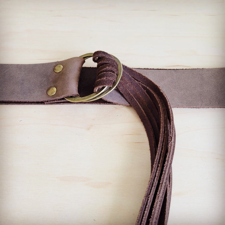 Brown leather belt with brushed metal buckle and distressed fringe strands
