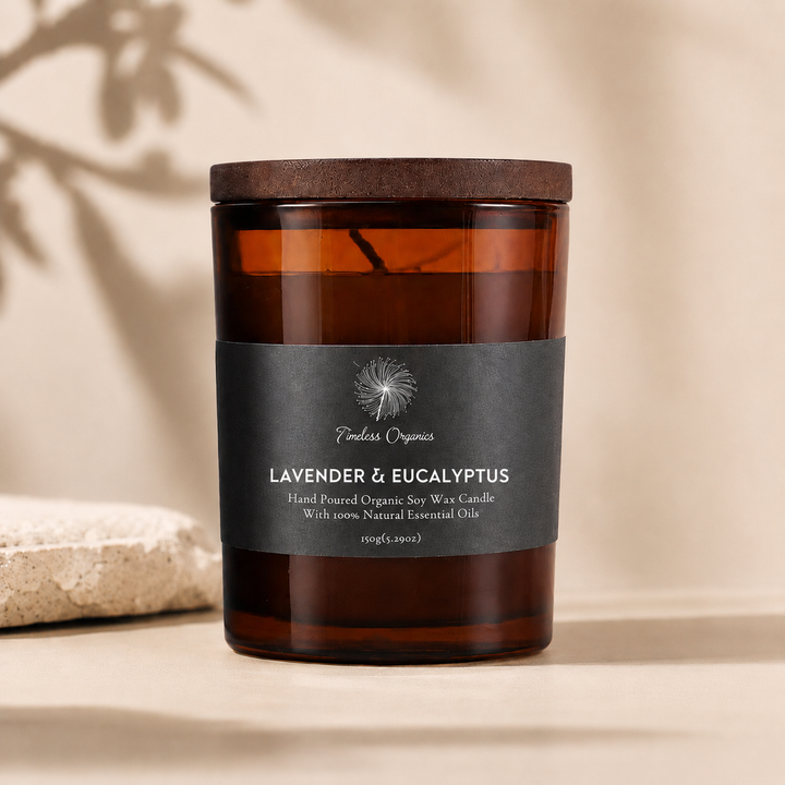 Lavender &amp; eucalyptus scented candle in amber glass jar with black label, unlit