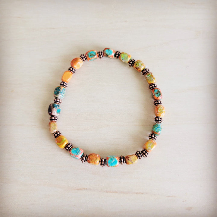 Stretch beaded bracelet with orange, turquoise, and multicolor glass beads