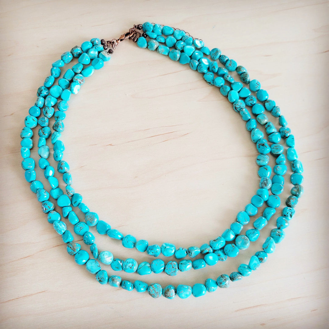Triple-strand turquoise bead necklace with metal clasp and layered bead rows
