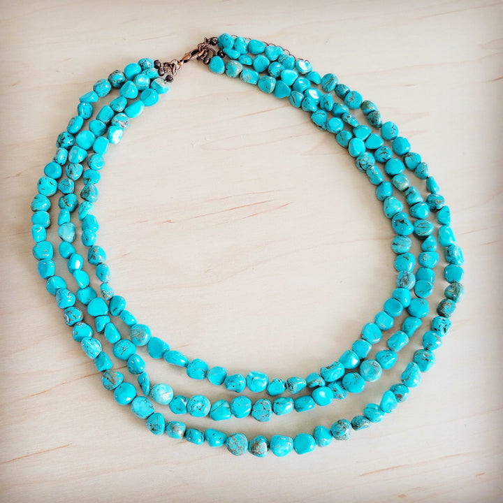 Triple-strand turquoise bead necklace with metal clasp and layered bead rows