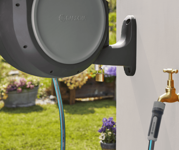 Retractable hose reel mounting bracket with blue hose and brass water connector