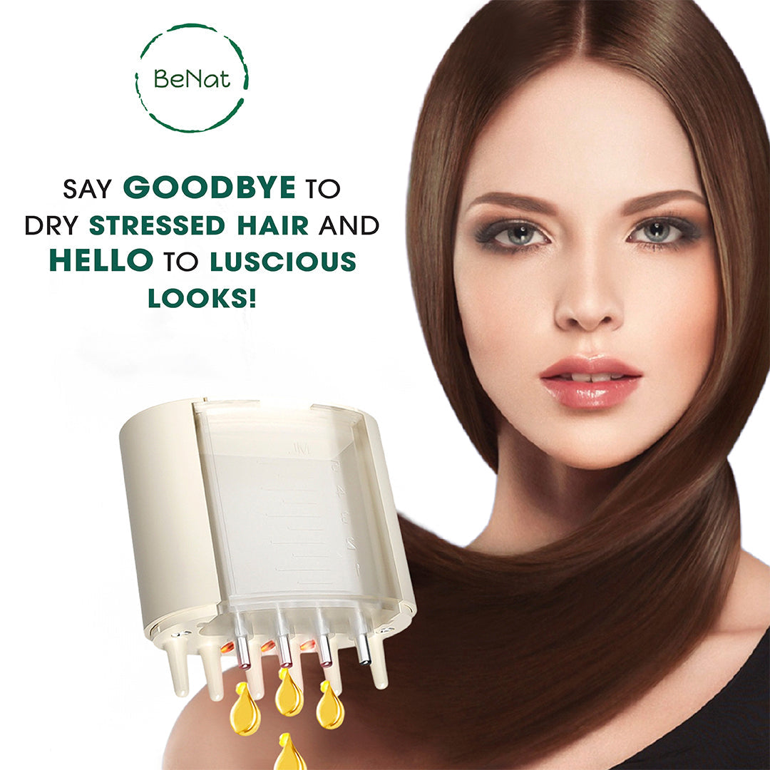 Electric oil applicator and scalp massager above forehead area with nozzle tips releasing oil