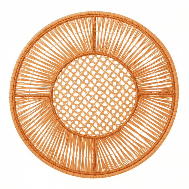 Round handwoven iraca placemat in hot pink with open lattice center and woven spokes