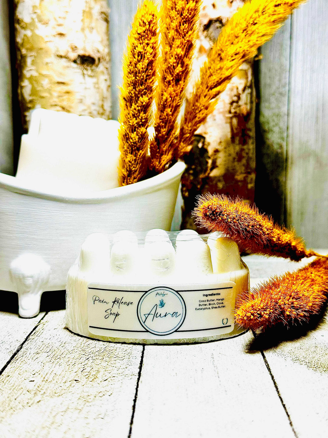 Pain-relieving bath salt soak tub with Aura label and capped bottle